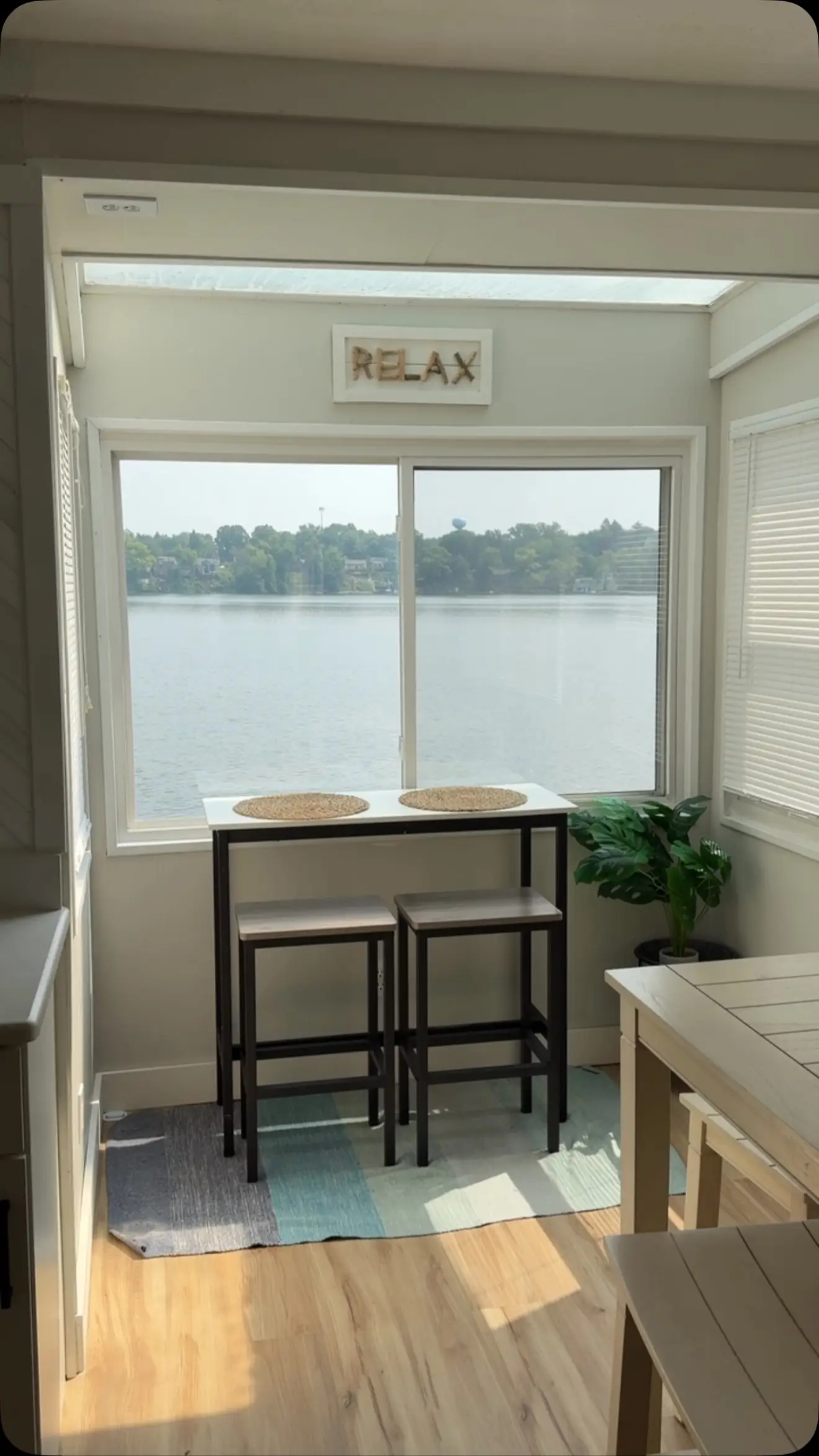 Screened porch dining nook looking out over the water